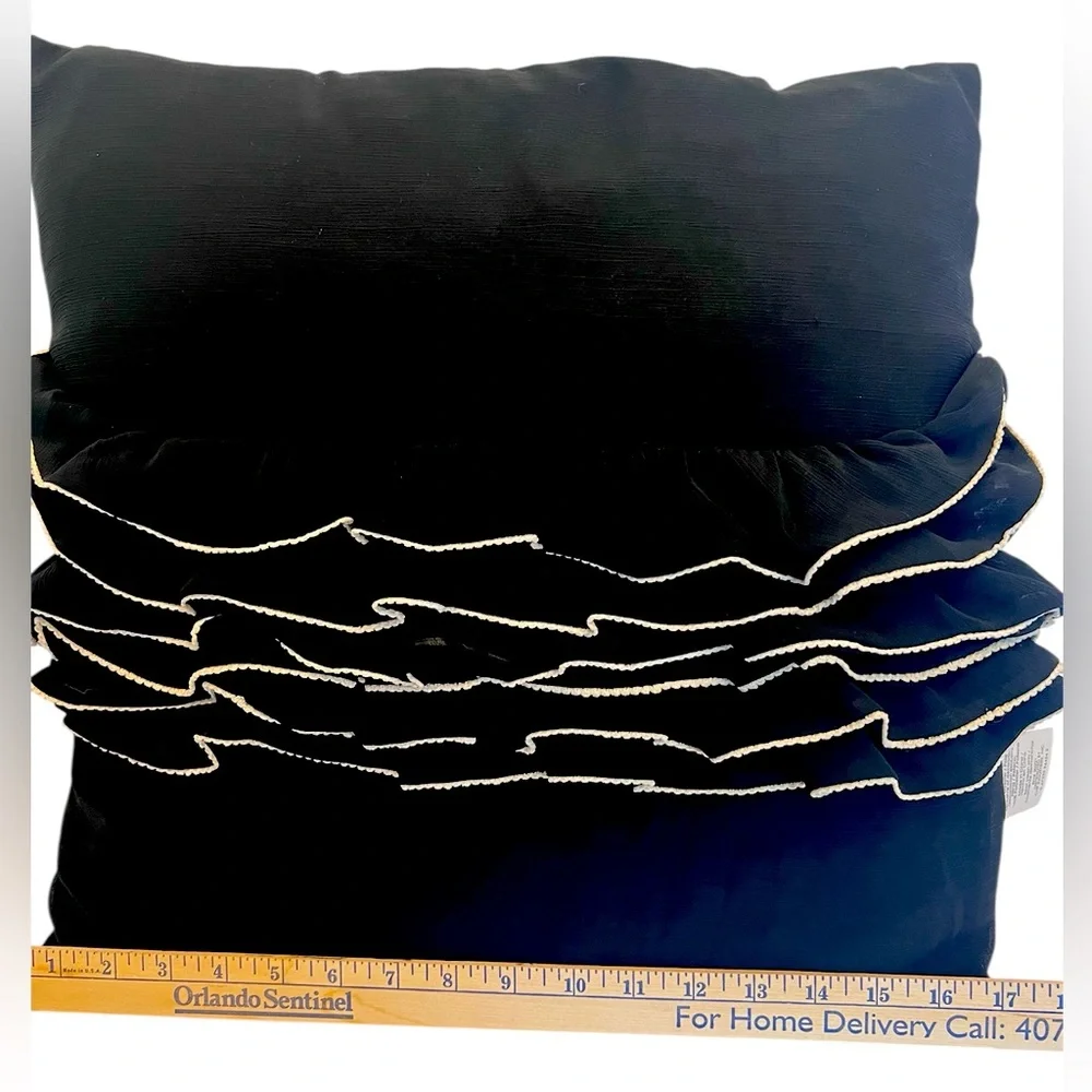 Elegant Black and Cream Ruffled Throw Pillow by Daisy Fuentes.